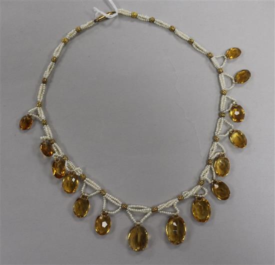 A triple strand seed pearl and graduated facet cut citrine set fringe necklace, 42cm.